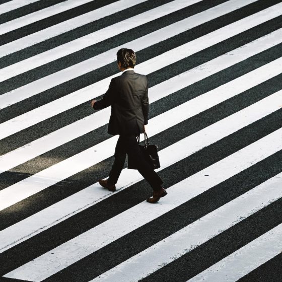 Man walking on pedestrian by Ryoji Iwata