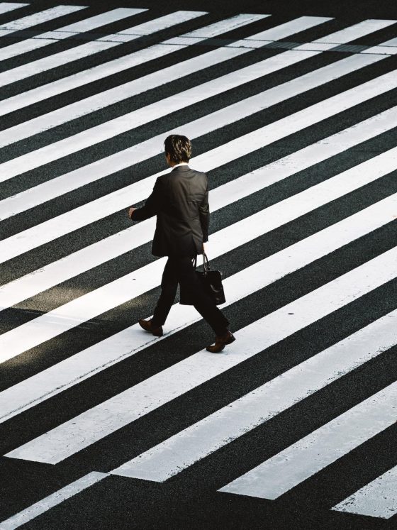 Man walking on pedestrian by Ryoji Iwata